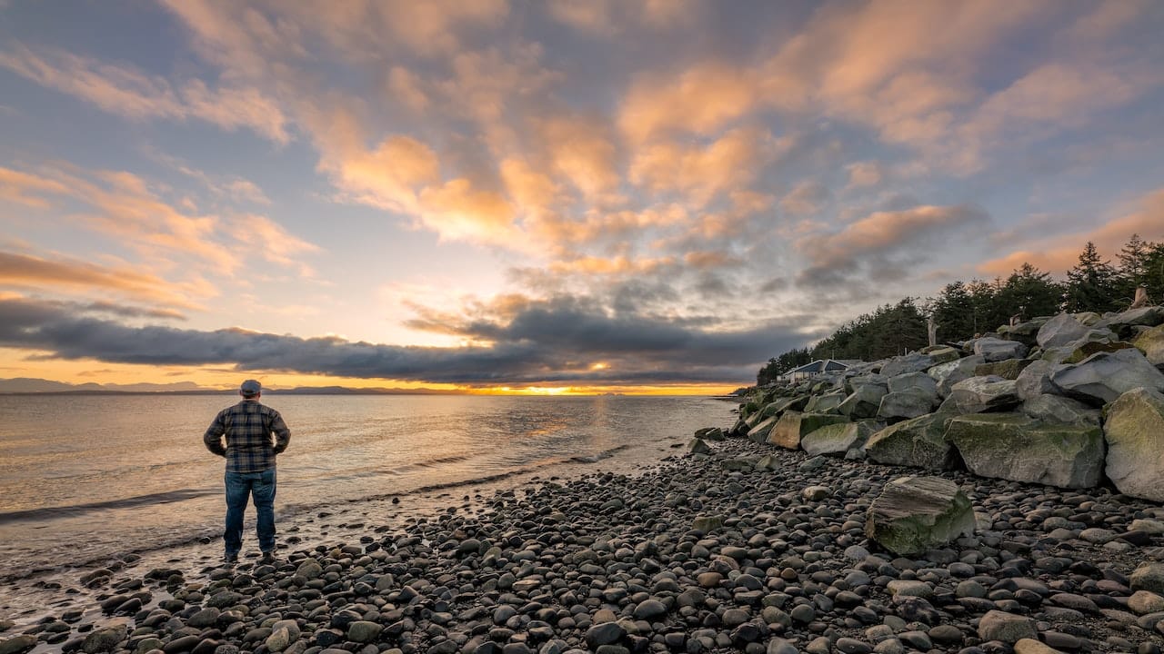 Man standing in ocean after finishing ADHD treatment.