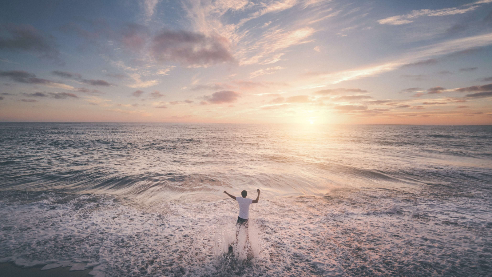 Man standing in ocean deciding when to see a therapist for anxiety