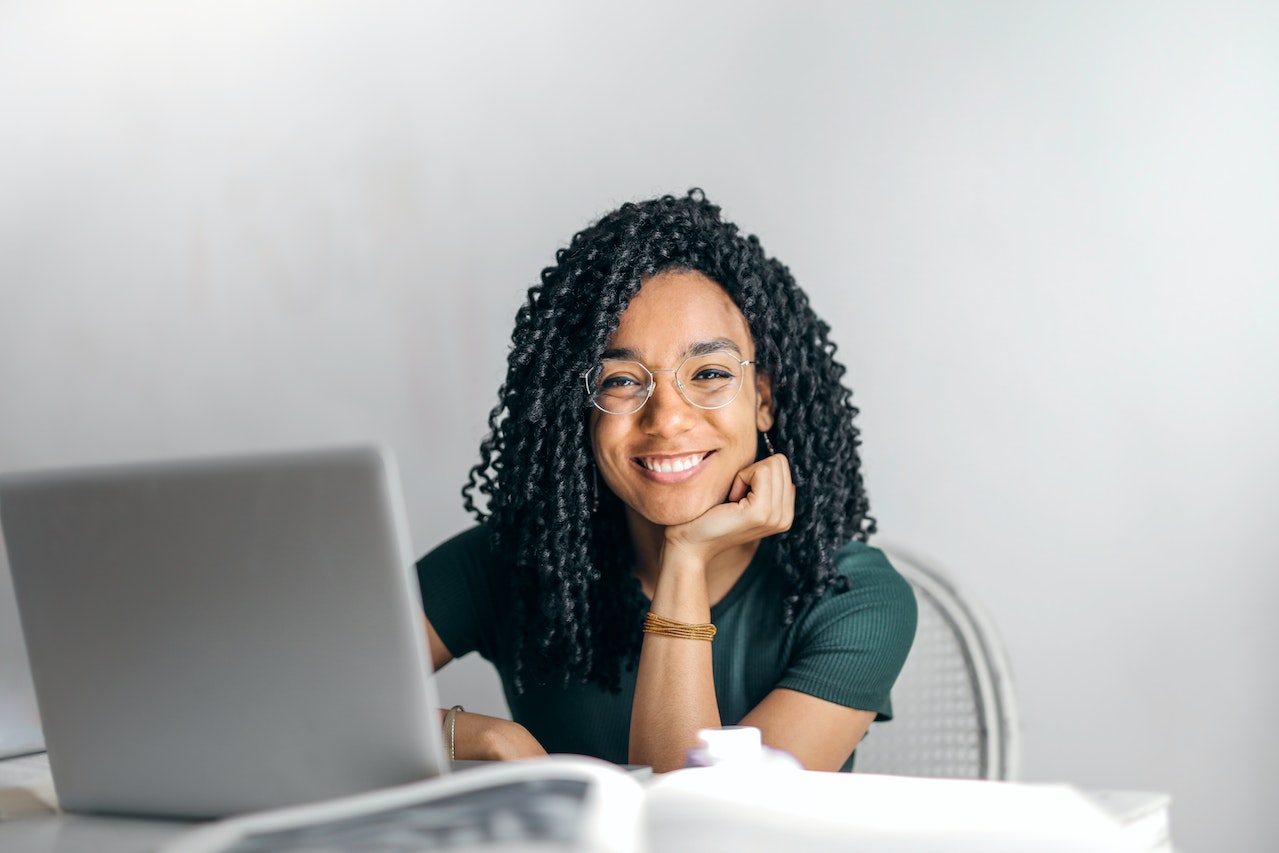 Woman smiling at computer after receiving online therapy in Seattle.