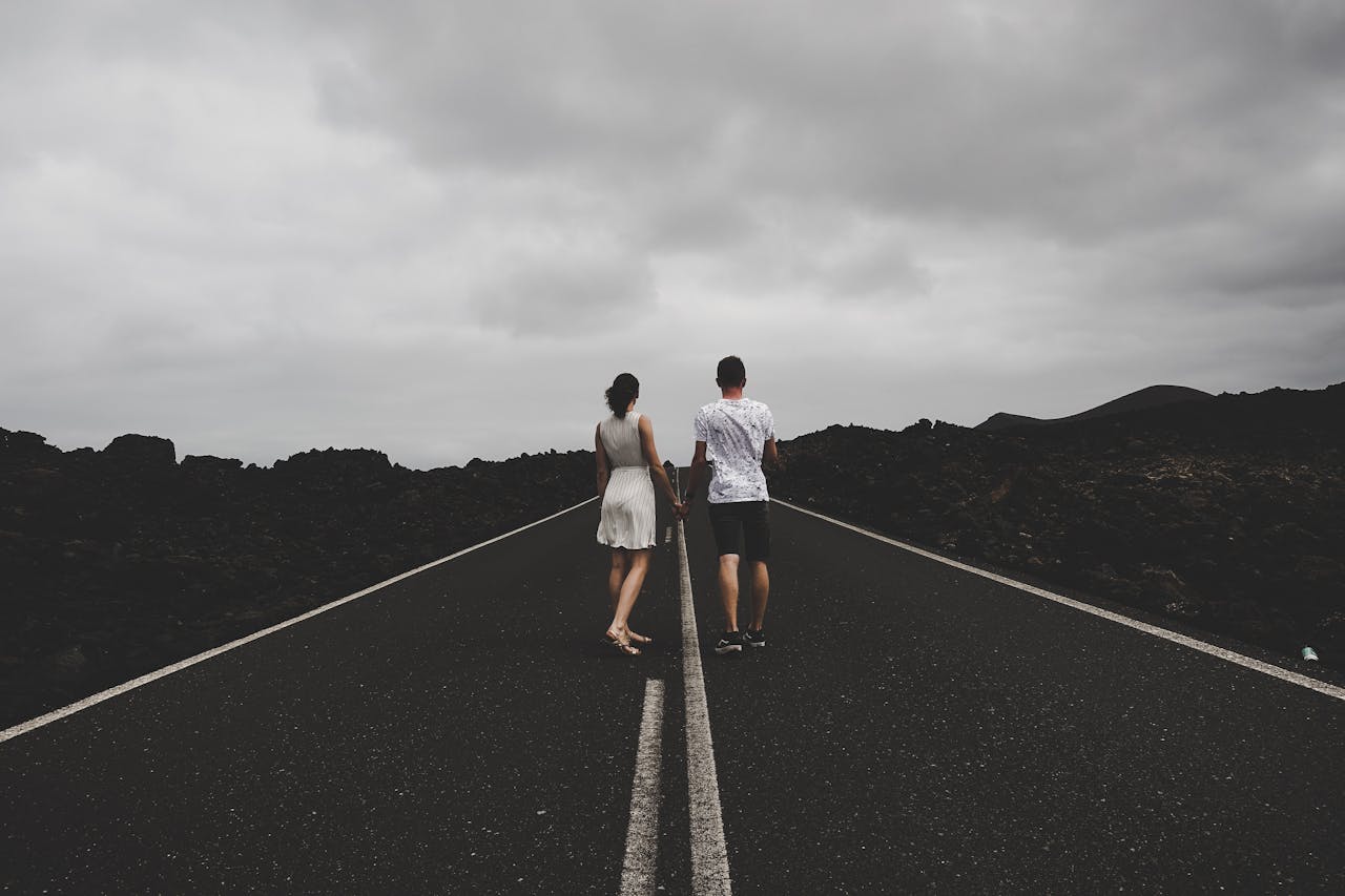 A couple standing together on a road navigating through ADHD and Relationships.