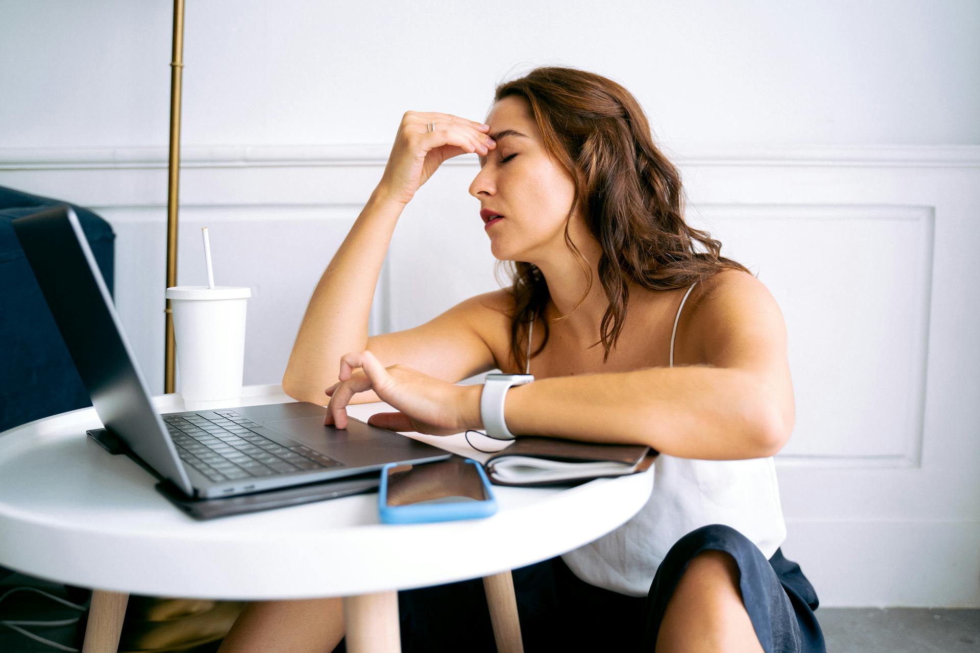 Woman sitting in fron of a computer stressed out suffering from depression