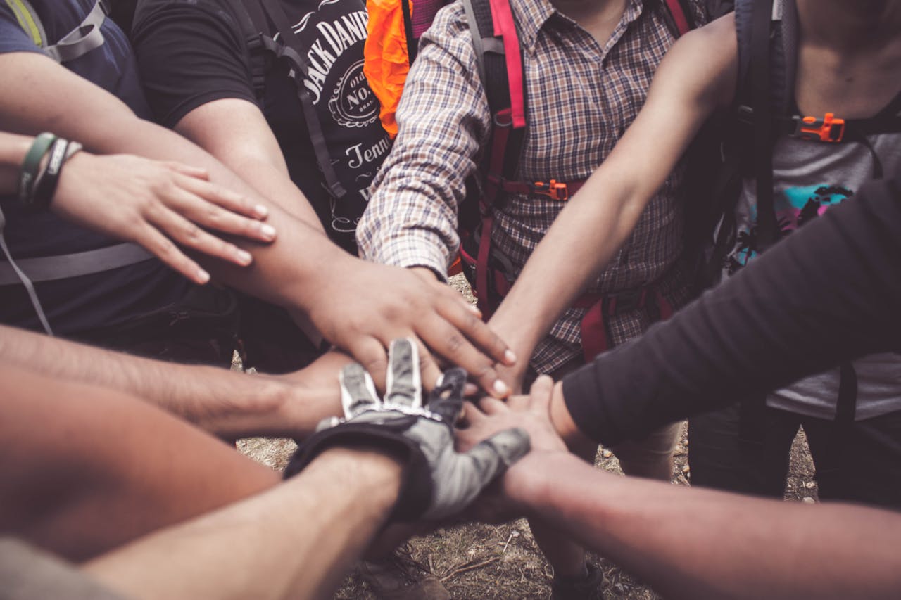 People Doing Group Hand Cheer thanks to therapy for Addiction, Childhood Trauma, and Codependency