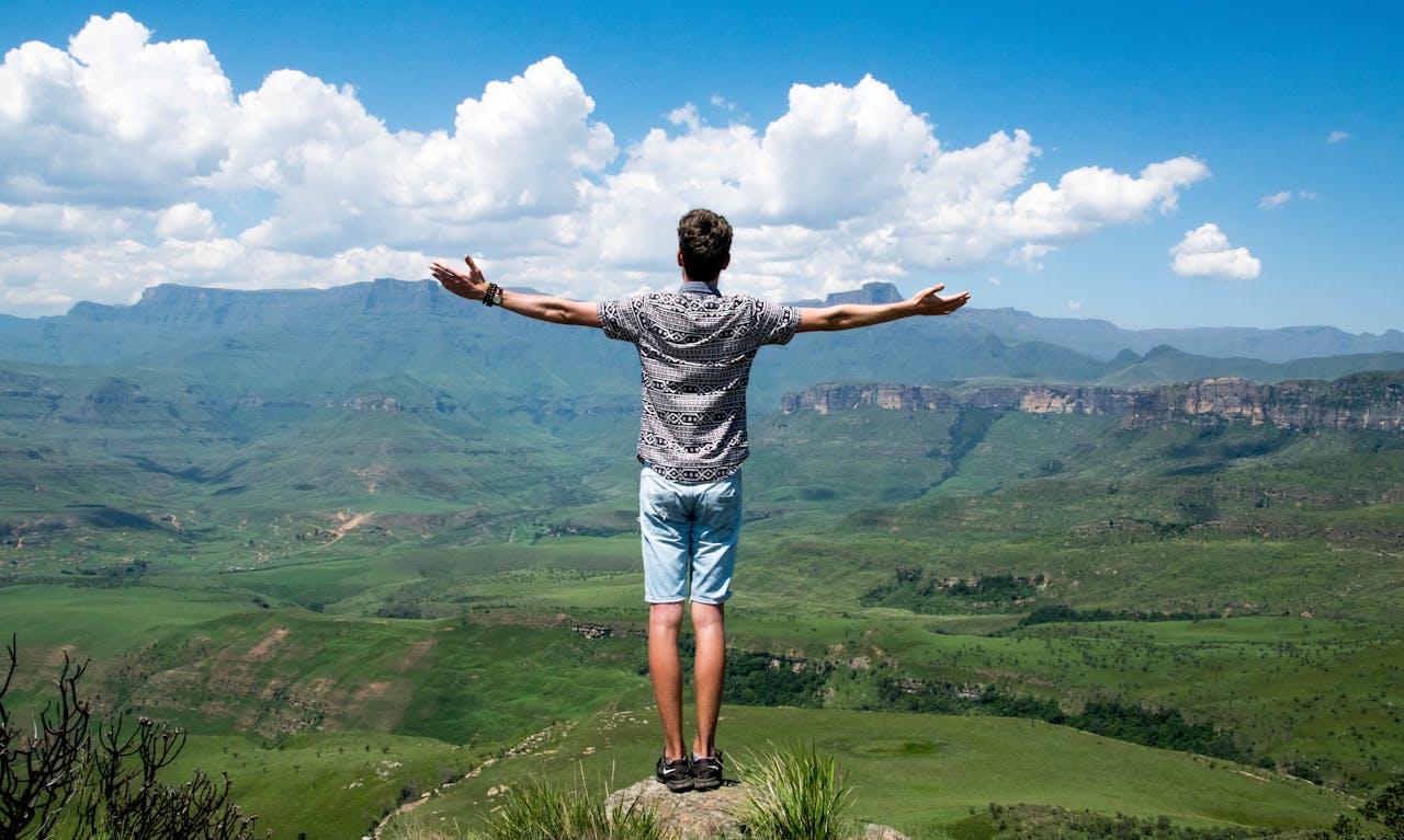 Man Standing on Elevated Surface reclaiming his self for higher power and inner healing