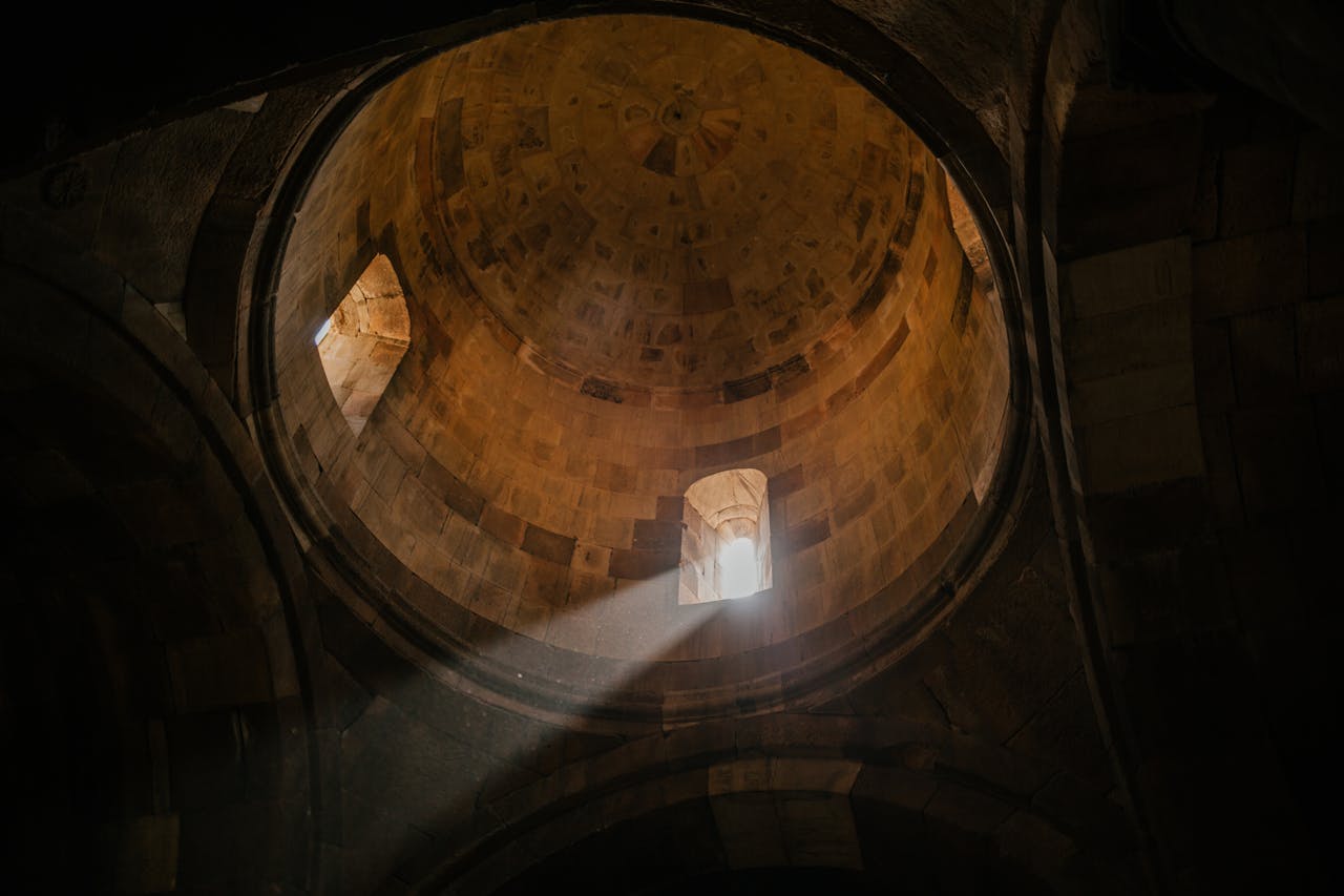 Old domed ceiling with sunlight shining through window representing to find hope after religious trauma