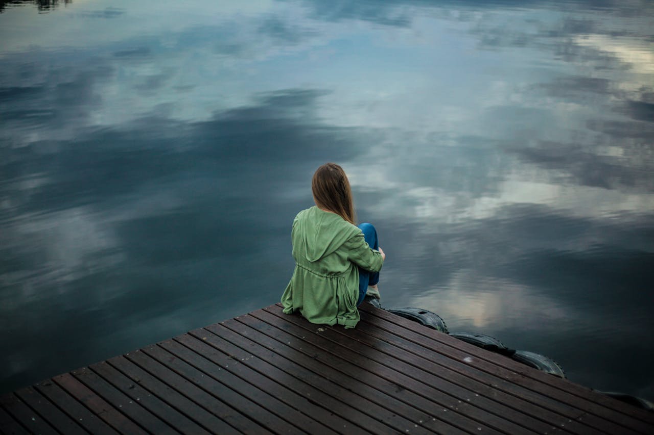 Woman practicing mindfulness meditation outdoors to overcome codependency and build self-worth