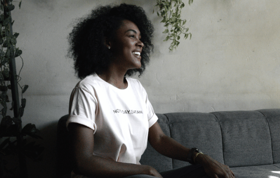 a woman sitting on a couch with a laptop