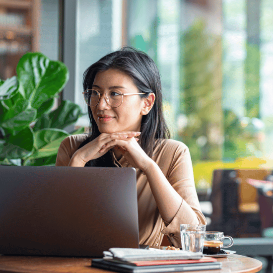 a woman working on a laptop in a cafe