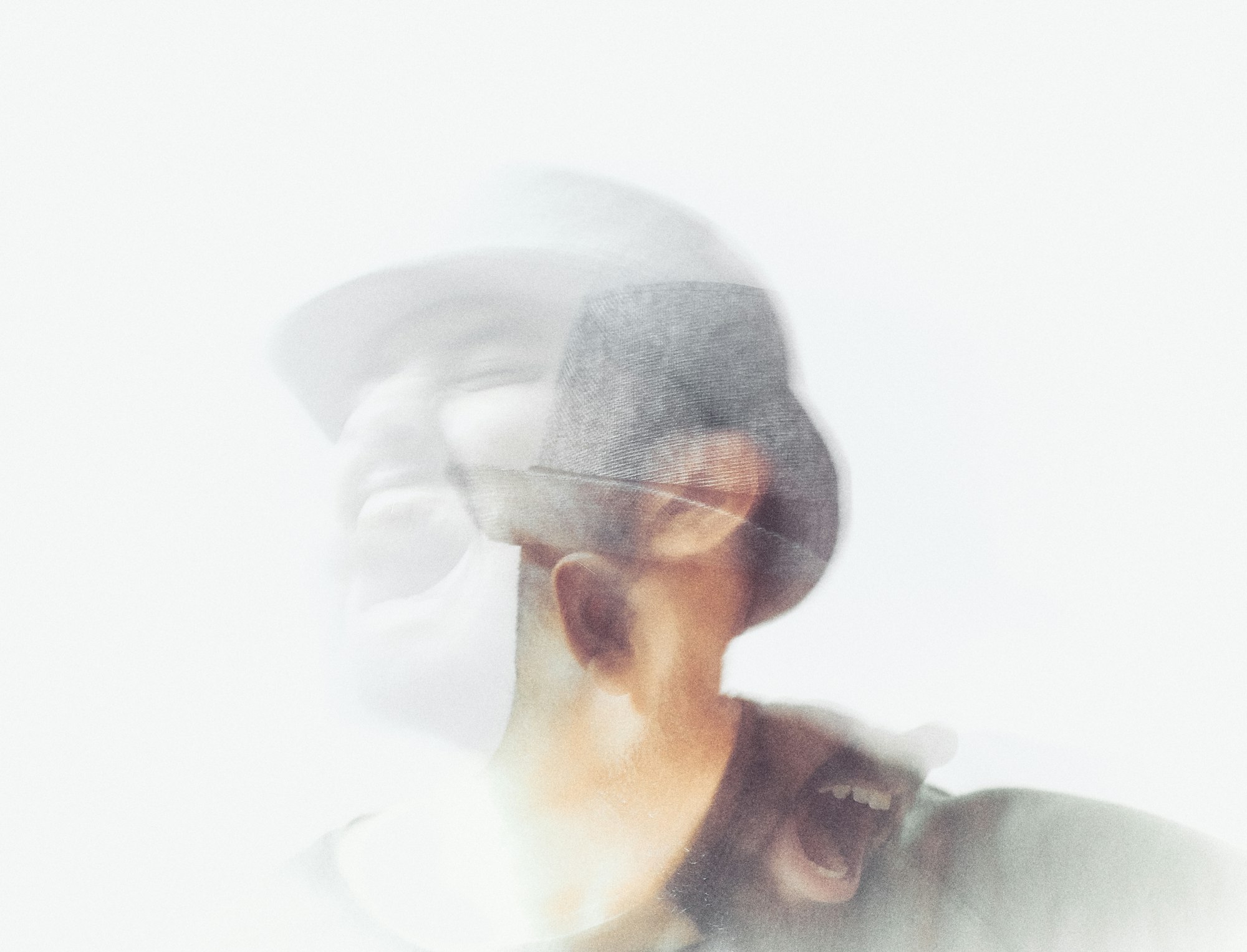 Blurred photo of a man screaming, before attending therapy for intrusive thoughts.