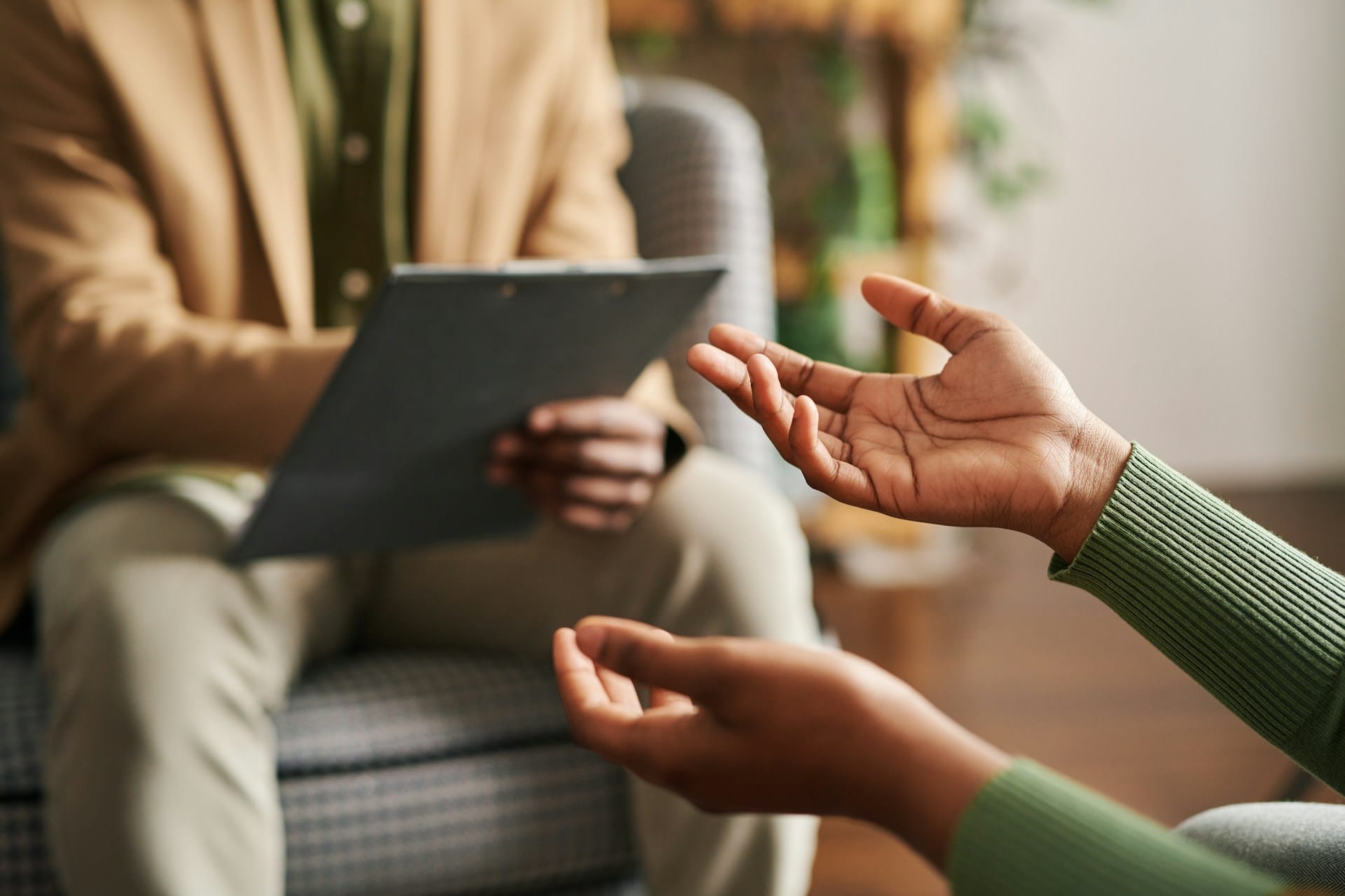 Hands of a patient sitting with their psychiatrist in a Seattle therapy office, discussing a mental health diagnosis.