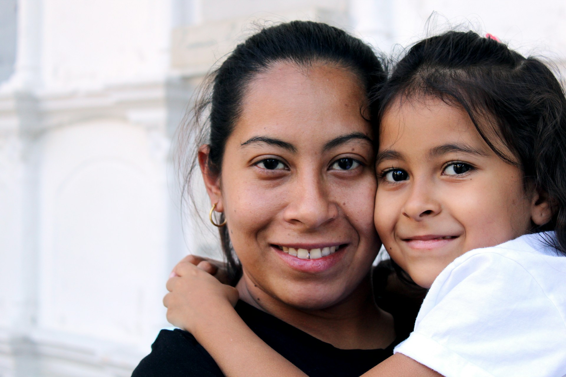 Close-up of mom and daughter smiling after the daughter had shared parenting time with her dad.